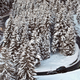 A photo of cars driving along a snow-covered hairpin bend.